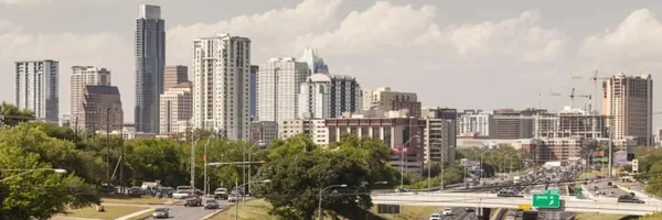 The Austin skyline with traffic moving along the highway in the foreground